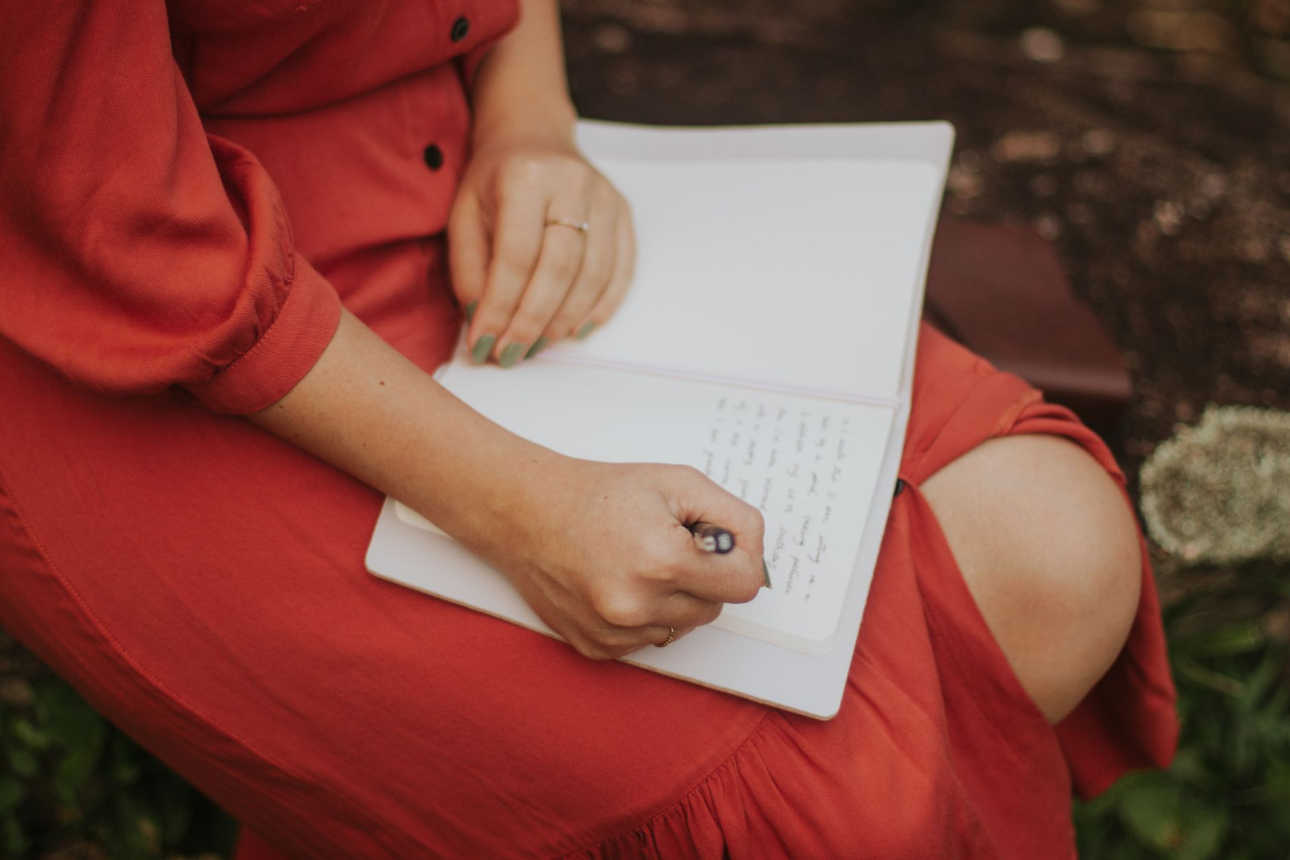 Travel writer documenting mountain landscape in journal